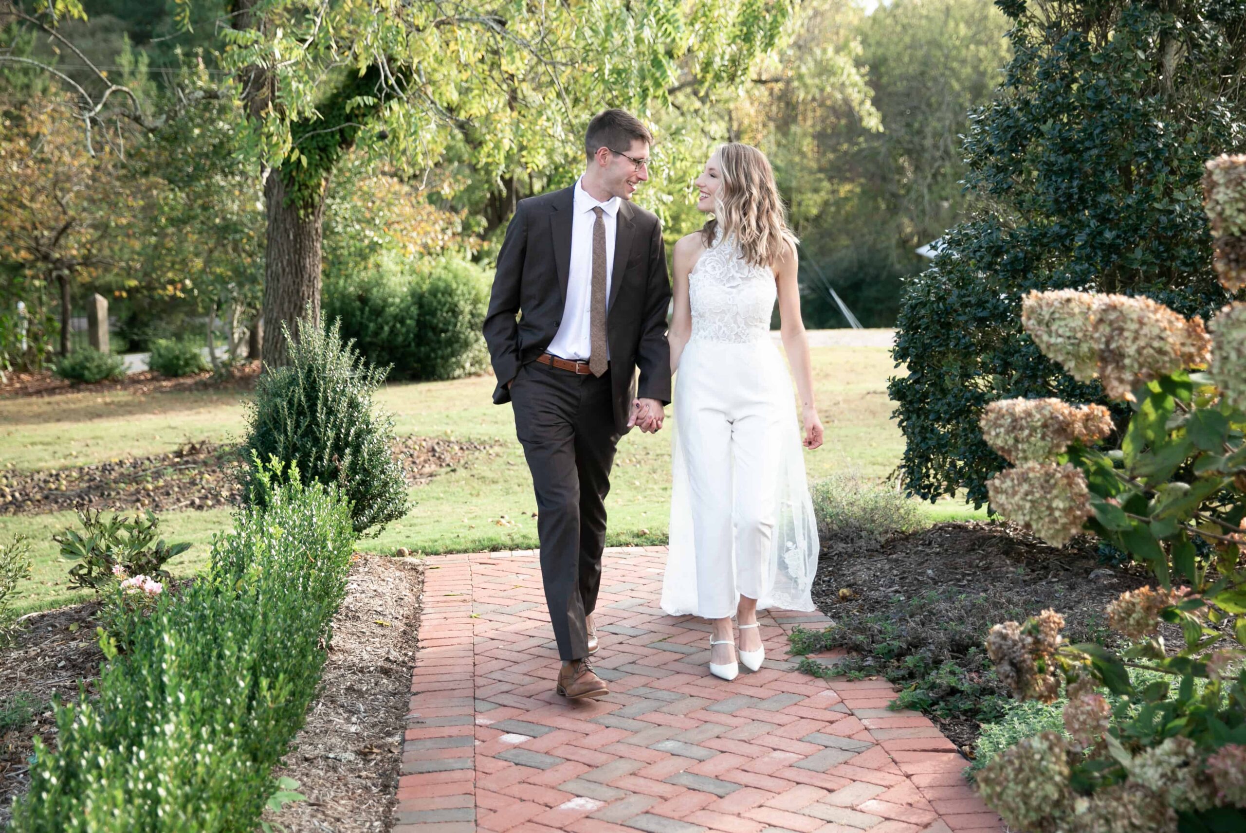 newlyweds romantic walk after tying the know at the Walnut Hill