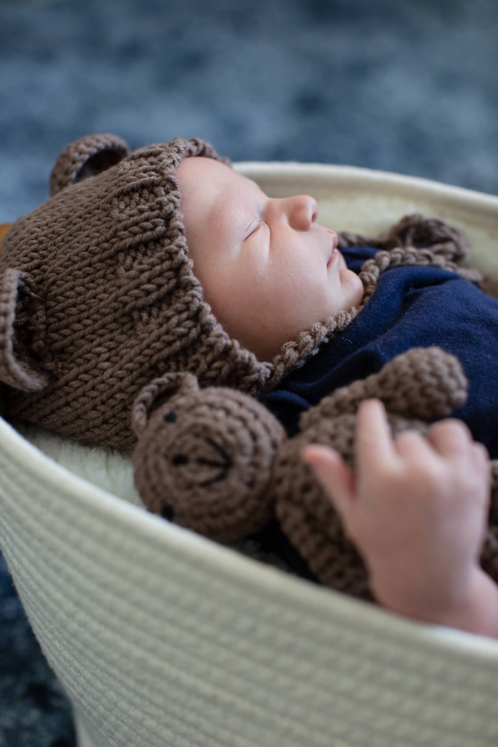 baby sleeping in a basket by Raleigh family photographer