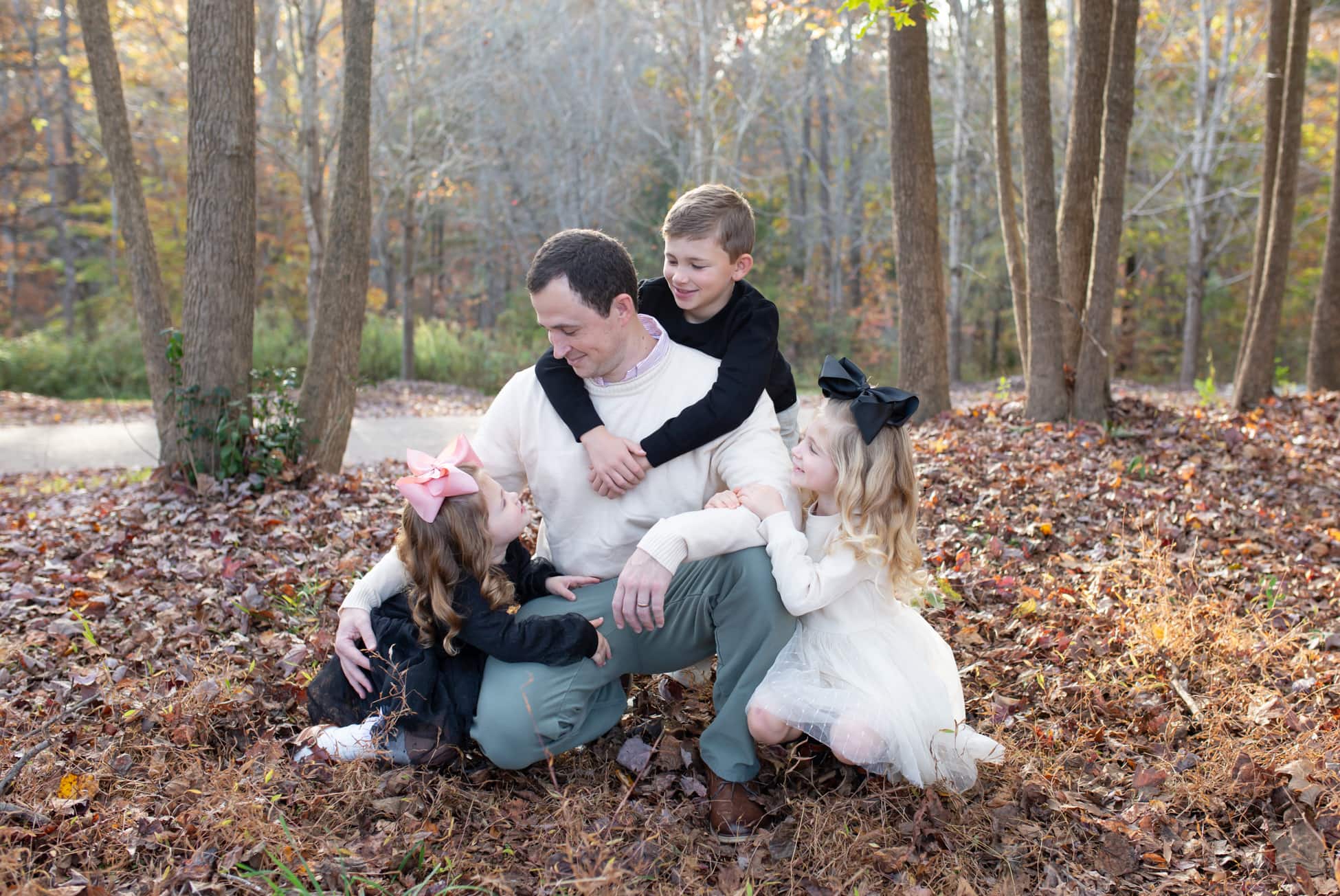 father playing with his children during fall in Wake Forest, NC