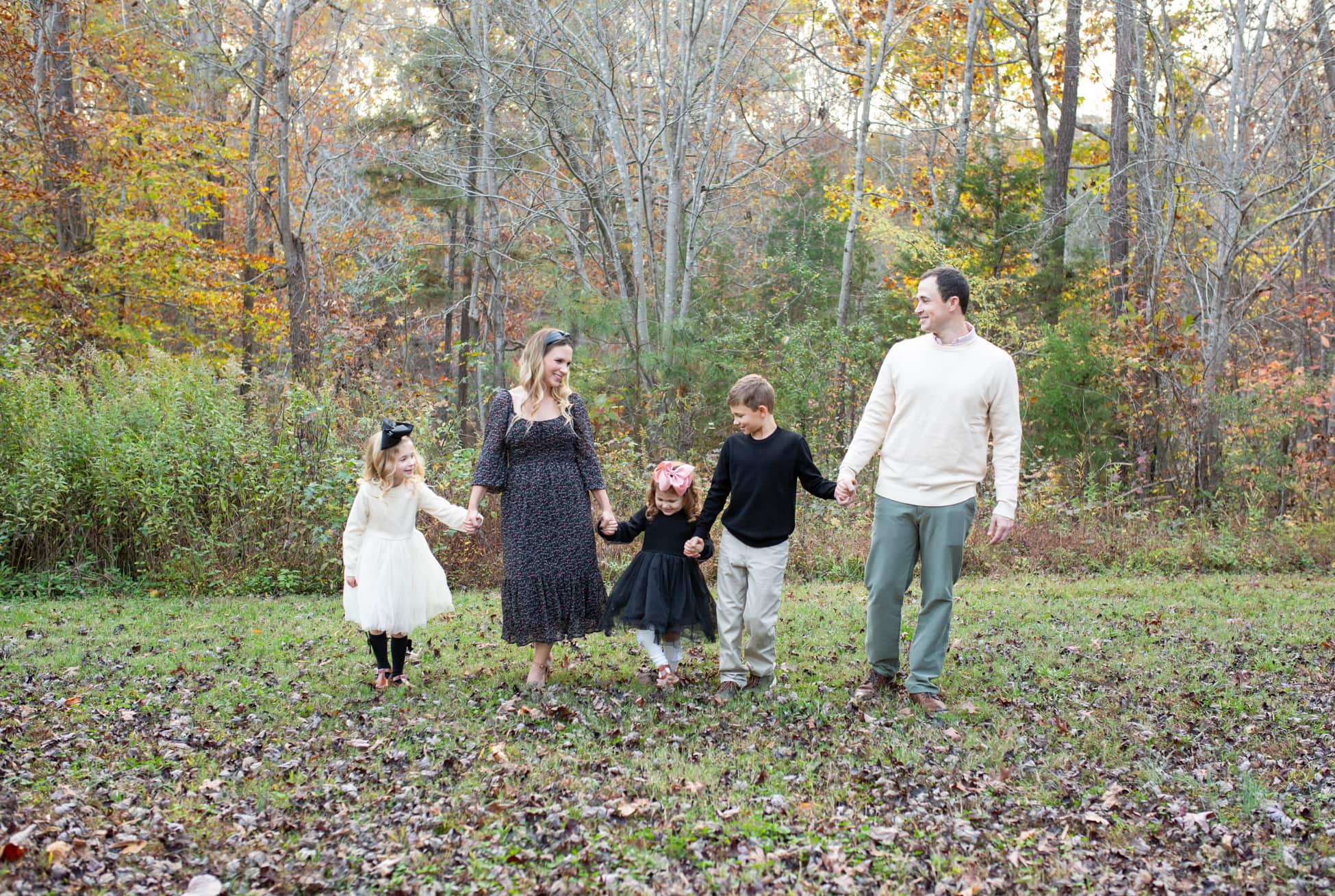A family of 5 walking in a park during fall season in North Carolina