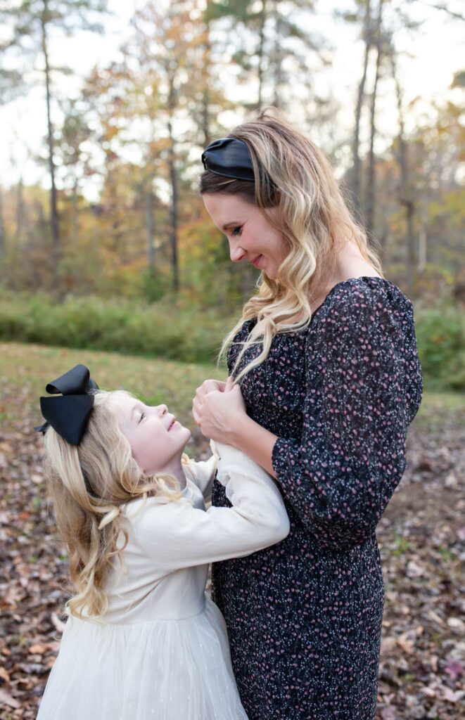 cute moment between mommy and her little daughter during a fall mini session in Wake Forest, NC