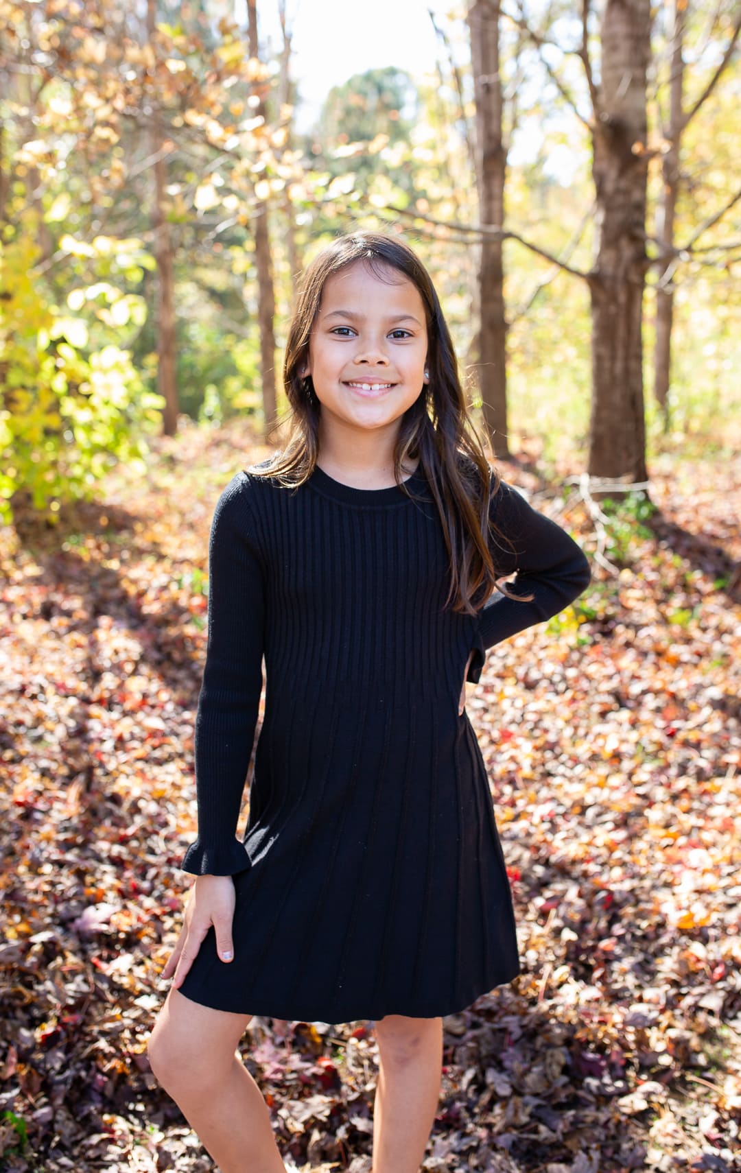 portrait of a young girl among fall leaves