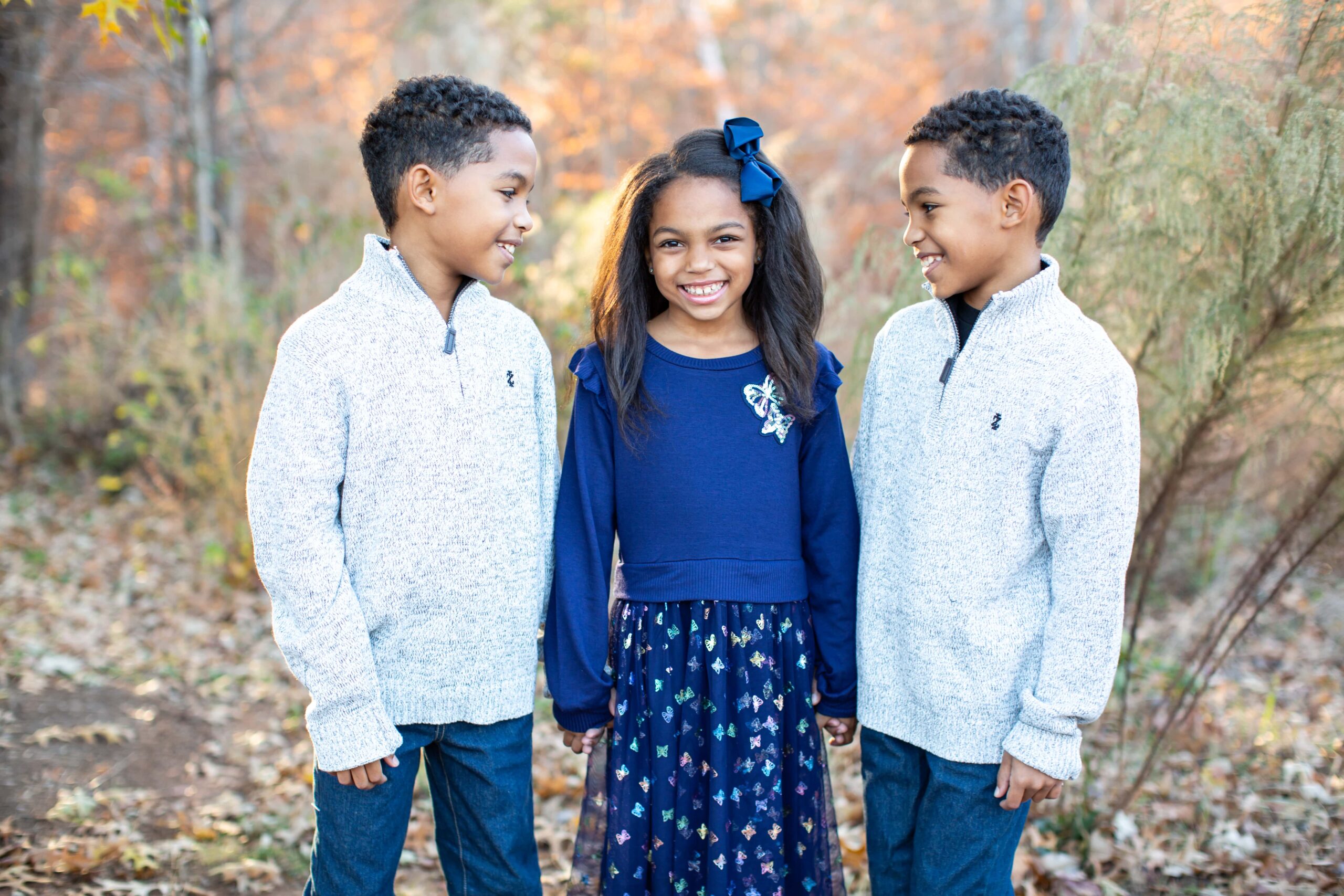triplets during fall portraits in Raleigh, NC captured by Magdalena Stefanek Photography, Raleigh family photographer.