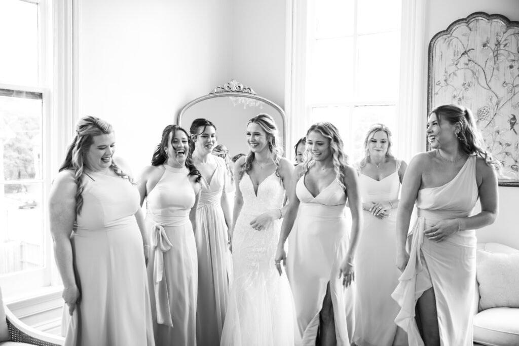 bride and her bridesmaids enjoying themselves at the bridal suite at the Main House Merrimon-Wynne House by Raleigh wedding photographer.