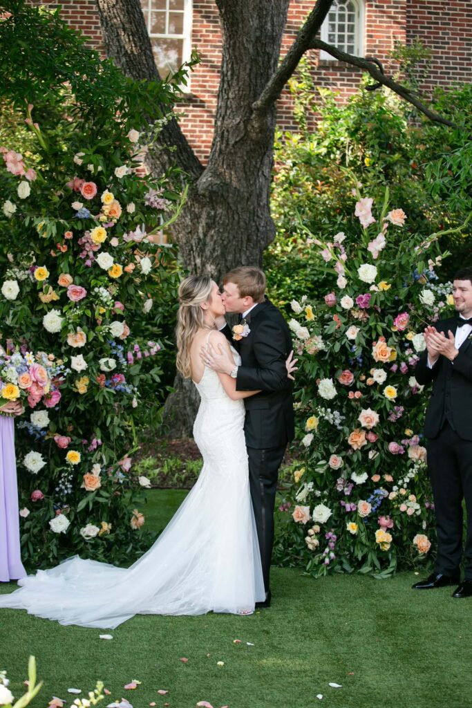 Bride and Groom first kiss after tying the knot at the Merrimon-Wynne House in Raleigh, NC