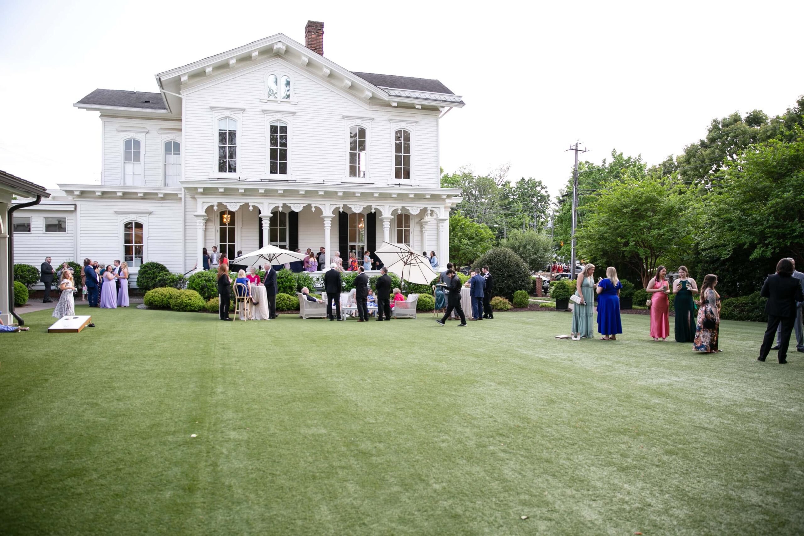 Wedding guests enjoying spring wedding by raleigh wedding photographer.