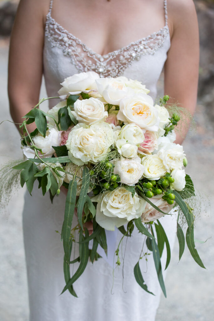 bride holding a lush white bridal bouquet. 