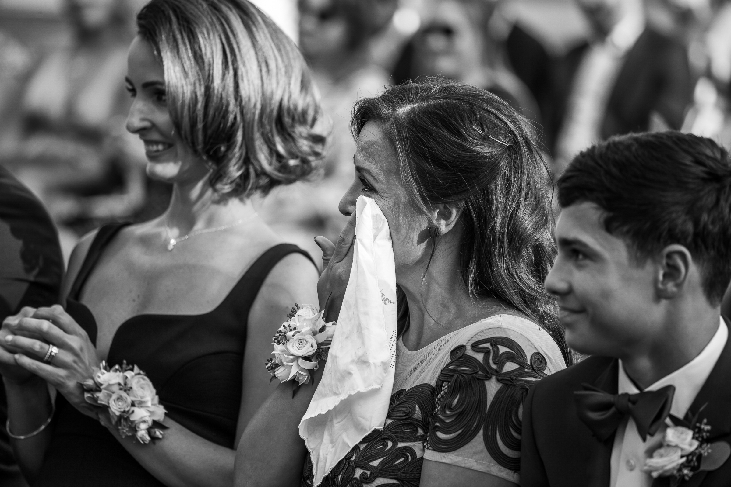 mother of the bride wiping happy tears during heartfelt wedding ceremony