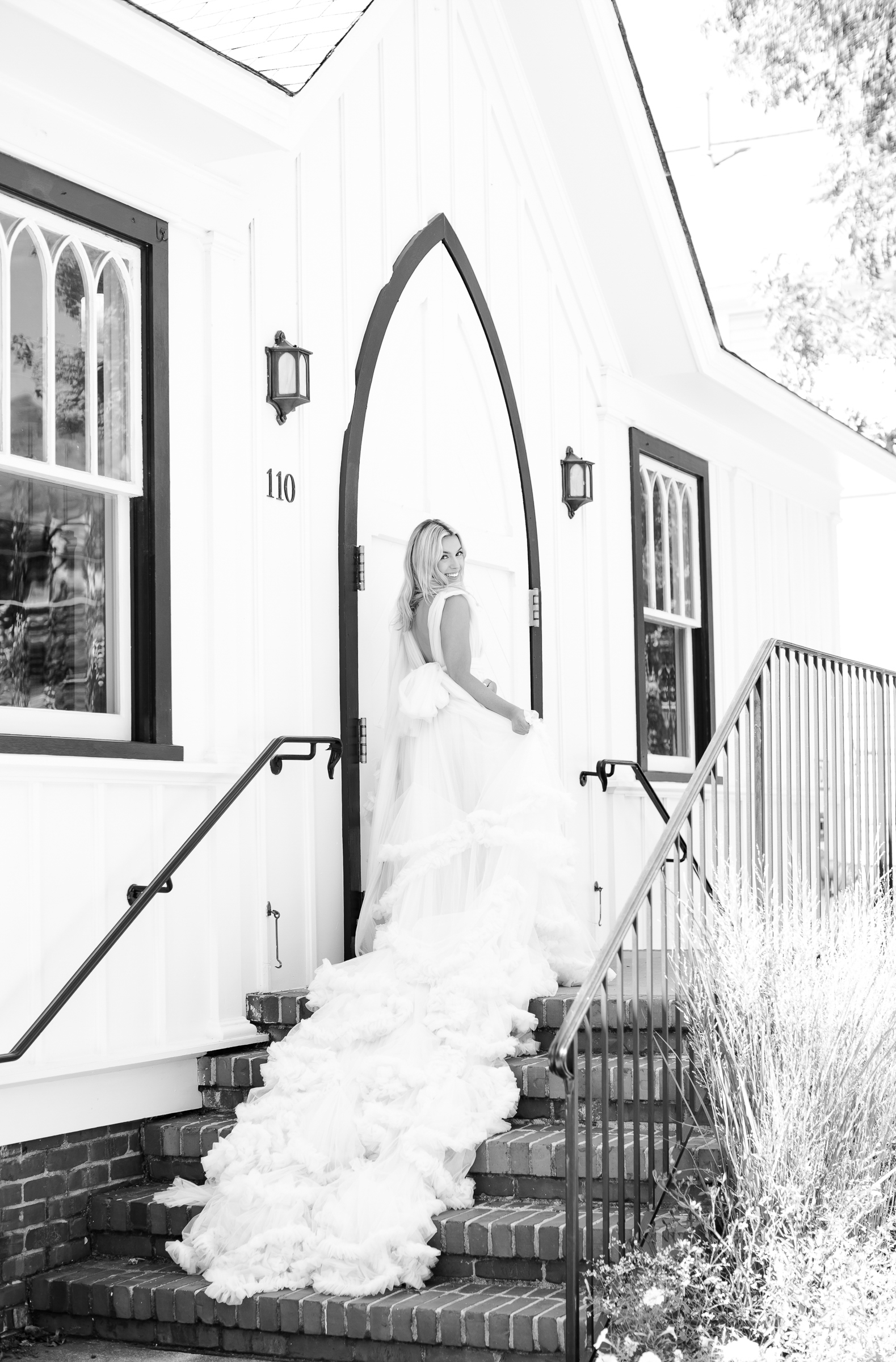 Bride smiling outside of All Saints Chapel in Raleigh. Raleigh wedding photographer.