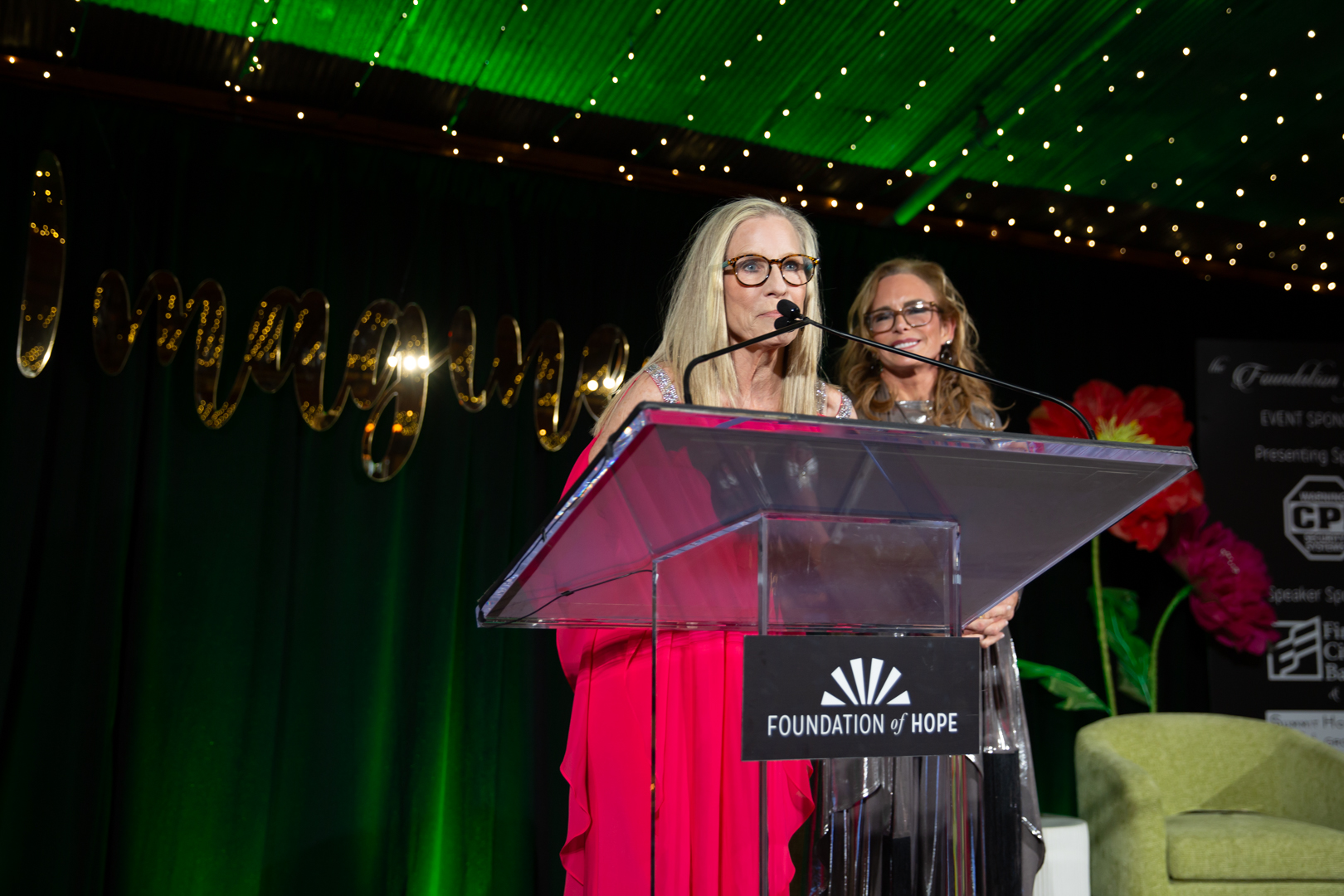 speaker at a podium during a charity gala by Foundation of Hope 