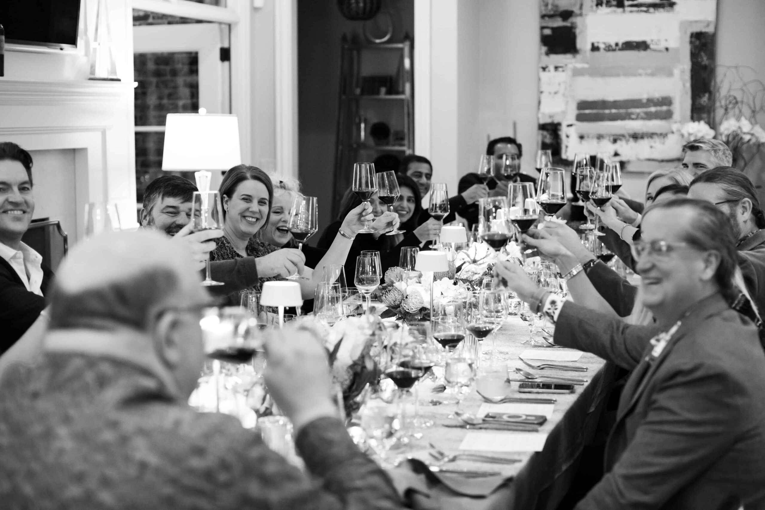 People raising their glasses during family celebration