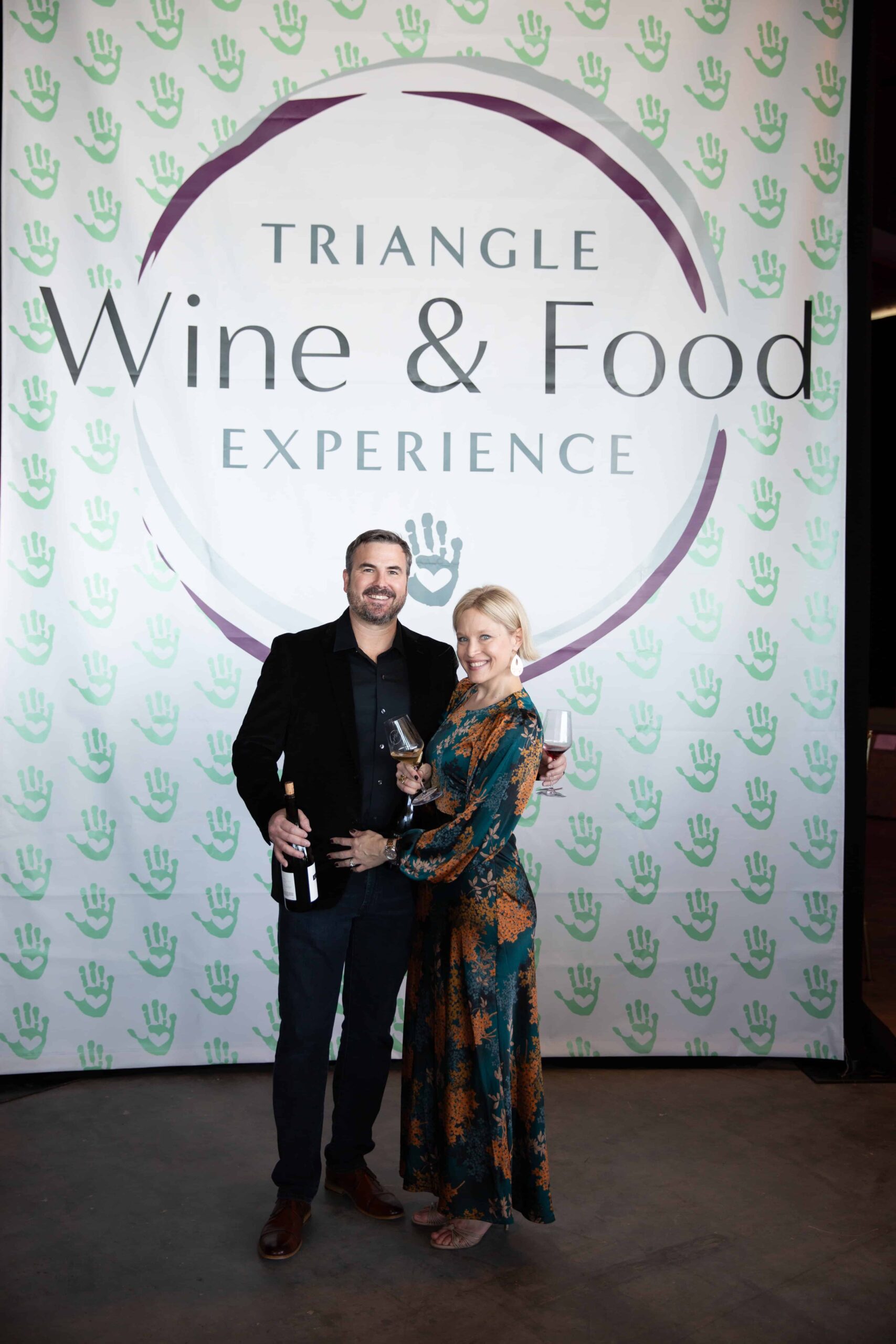 Raleigh photographer. A couple posing for a photo at a Charity event, Triangle Wine and Food Experience.