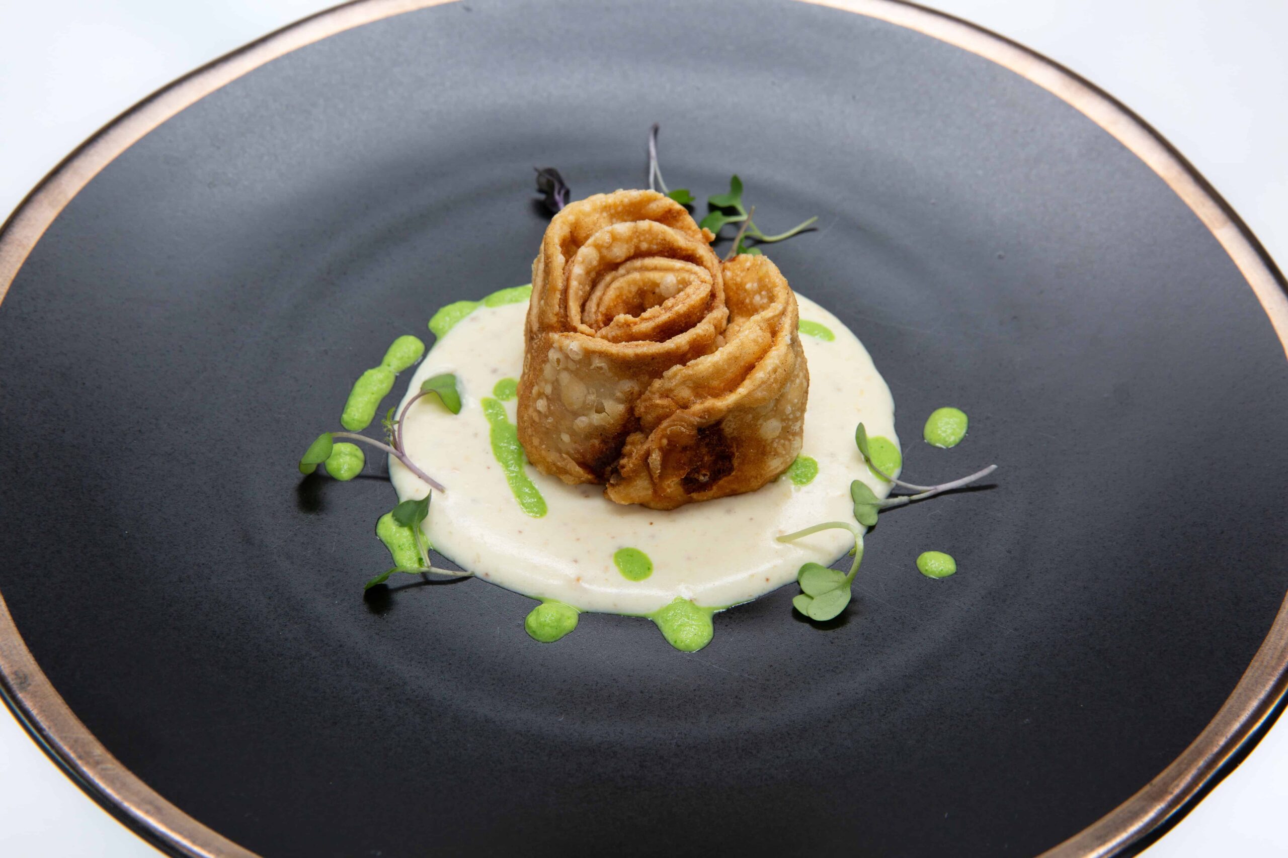 Gourmet appetizer nicely presented on a black plate. Food photographer Raleigh, NC