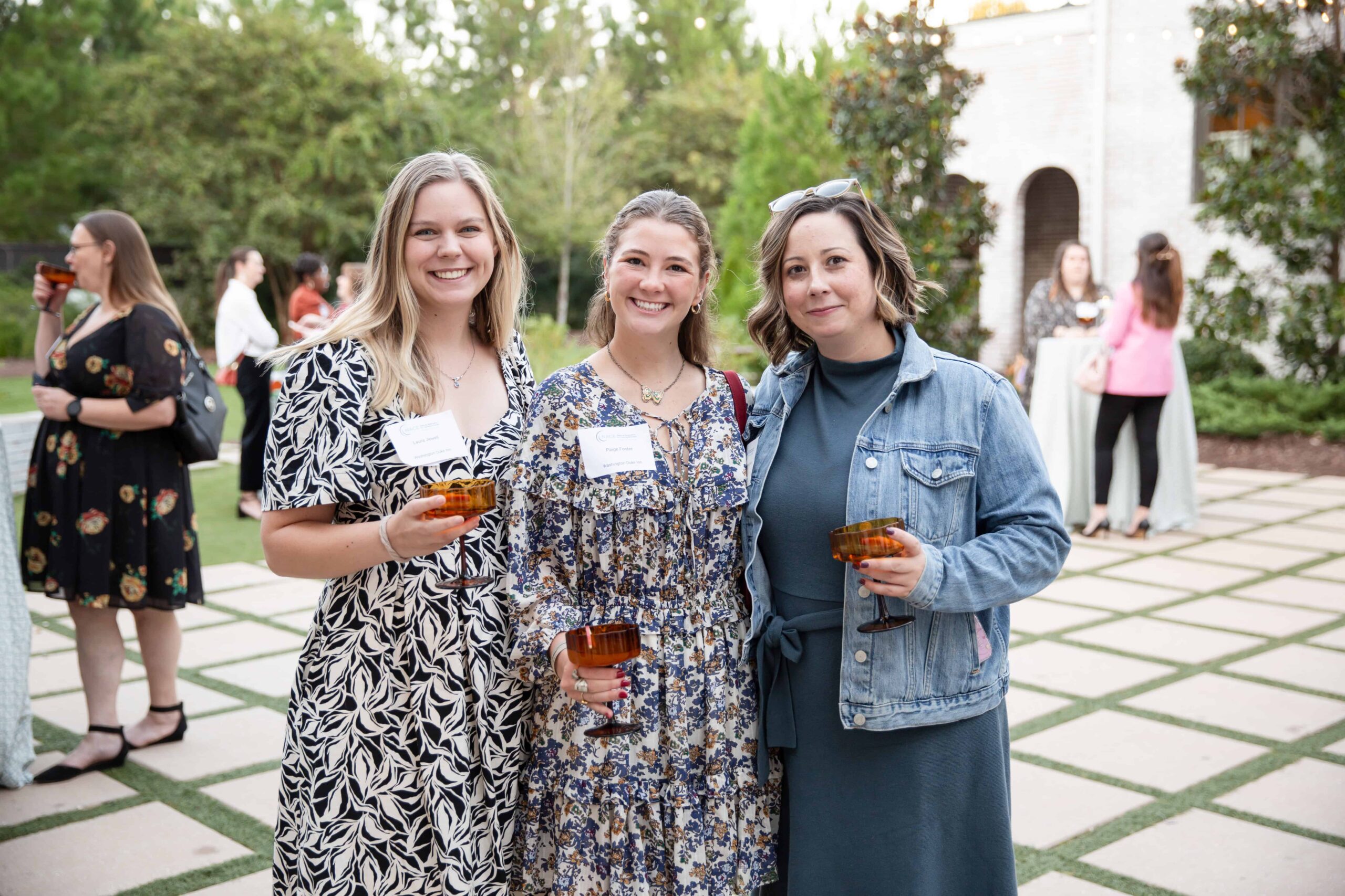 Three young professionals at a networking event are posing for a photo. Magdalena Stefanek Photography Raleigh event photographer