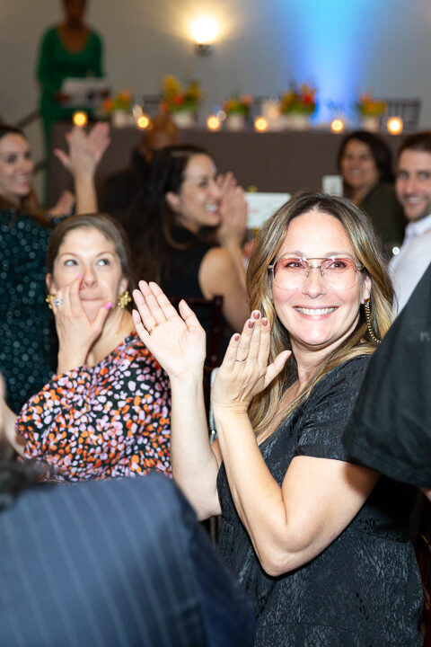 Woman clapping hands and cheering during a charity event in Raleigh NC