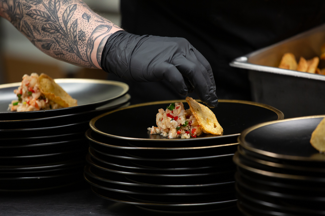 Triagle Chef plating their winning dish during cooking competition in Raleigh, NC. Raleigh Event photography.