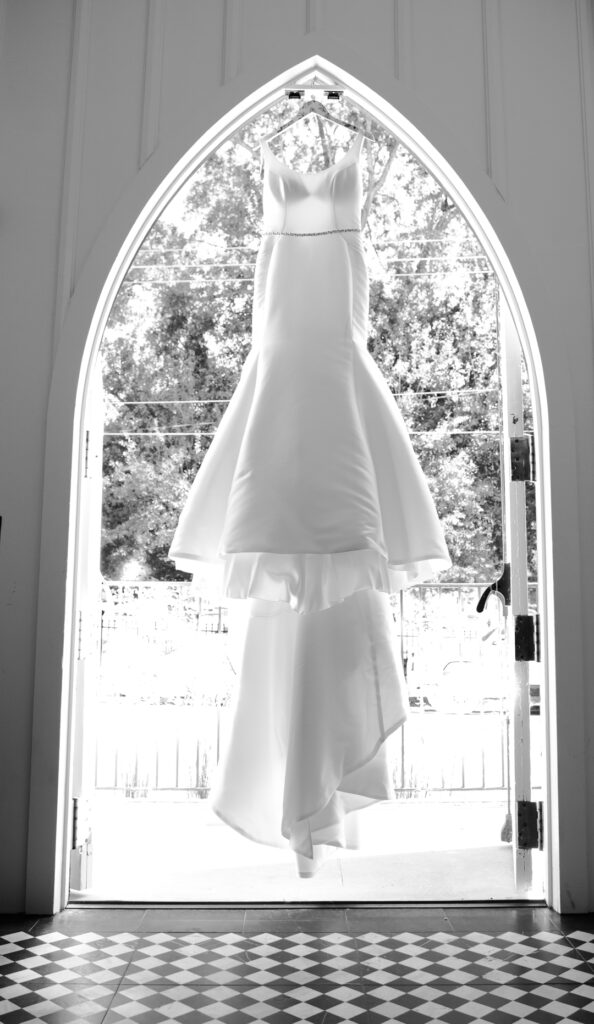 wedding dress hanging in the doorway