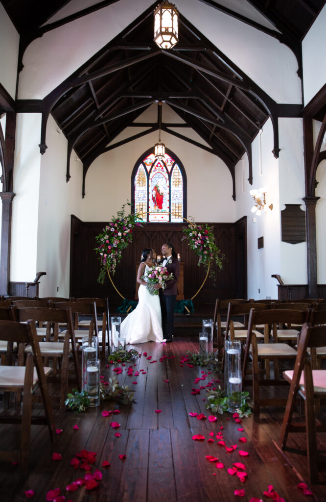 wedding ceremony setup at All Saints Chapel in Raleigh,NC. Couple at the altar at All Saints Chapel by Raleigh wedding photographer