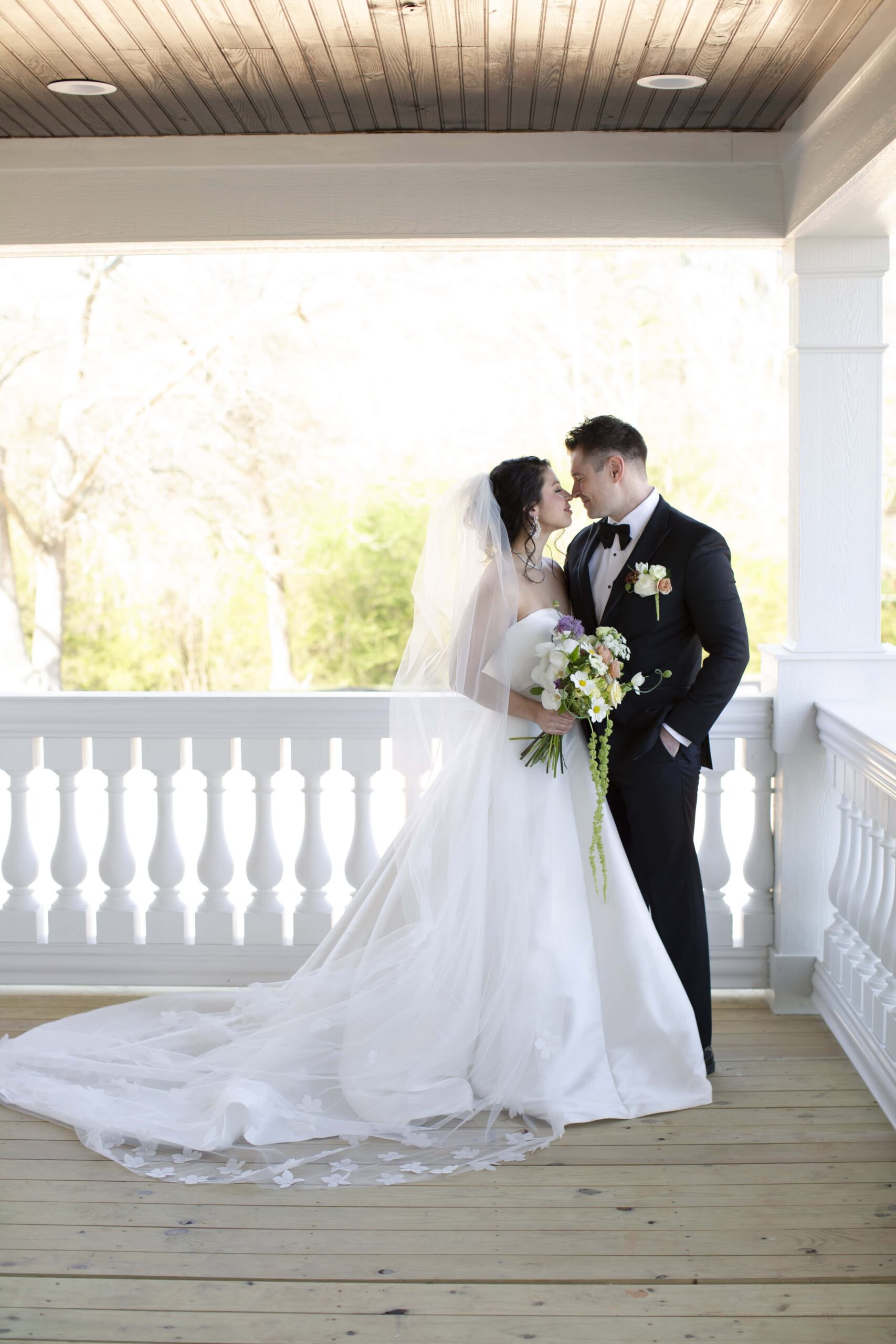 Bride and Groom portraits on the wrap-around porch of the historic home at Landon Estate. Magdalena Stefanek Photo