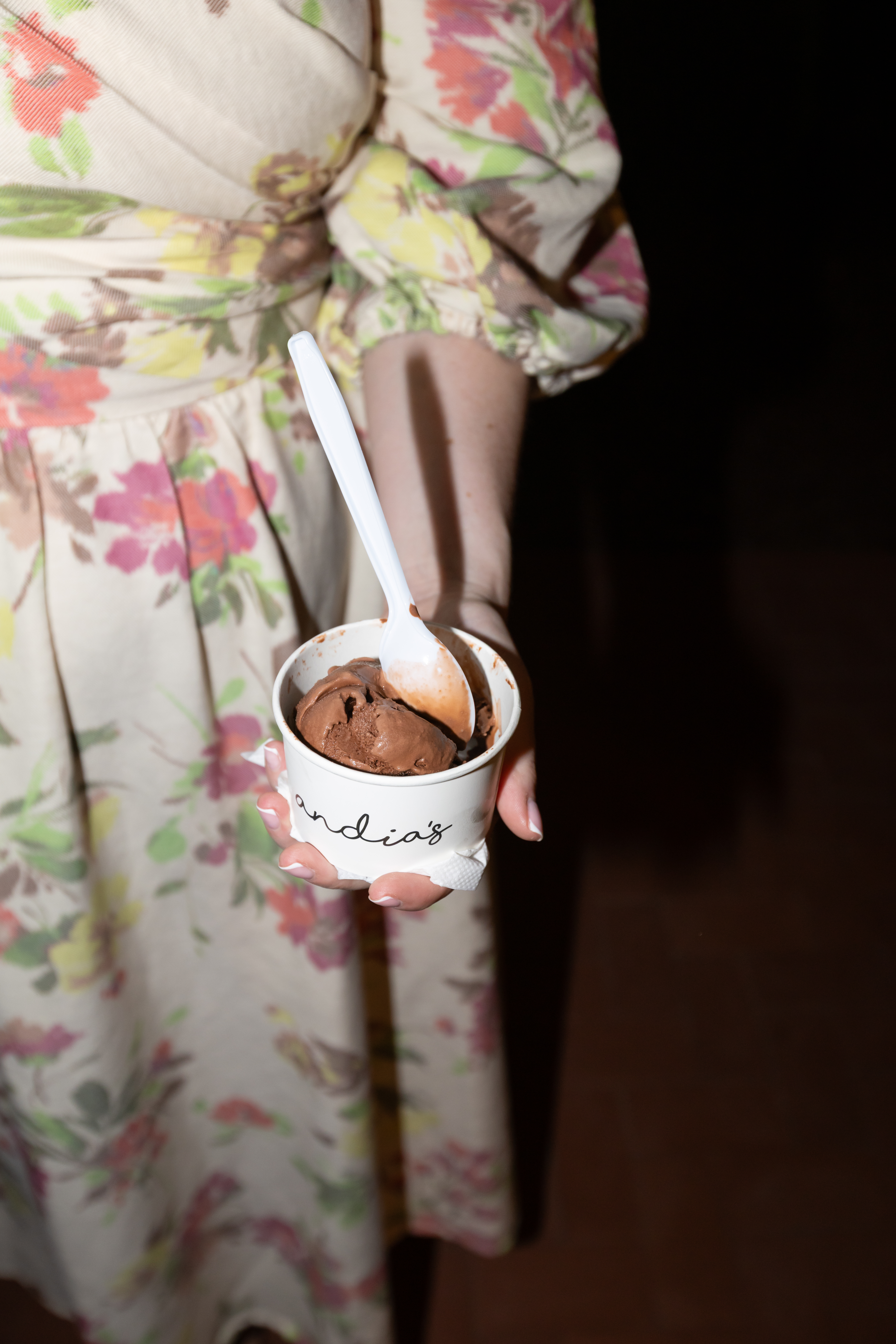 A wedding guest holding Andia's ice-cream cup at a wedding.
