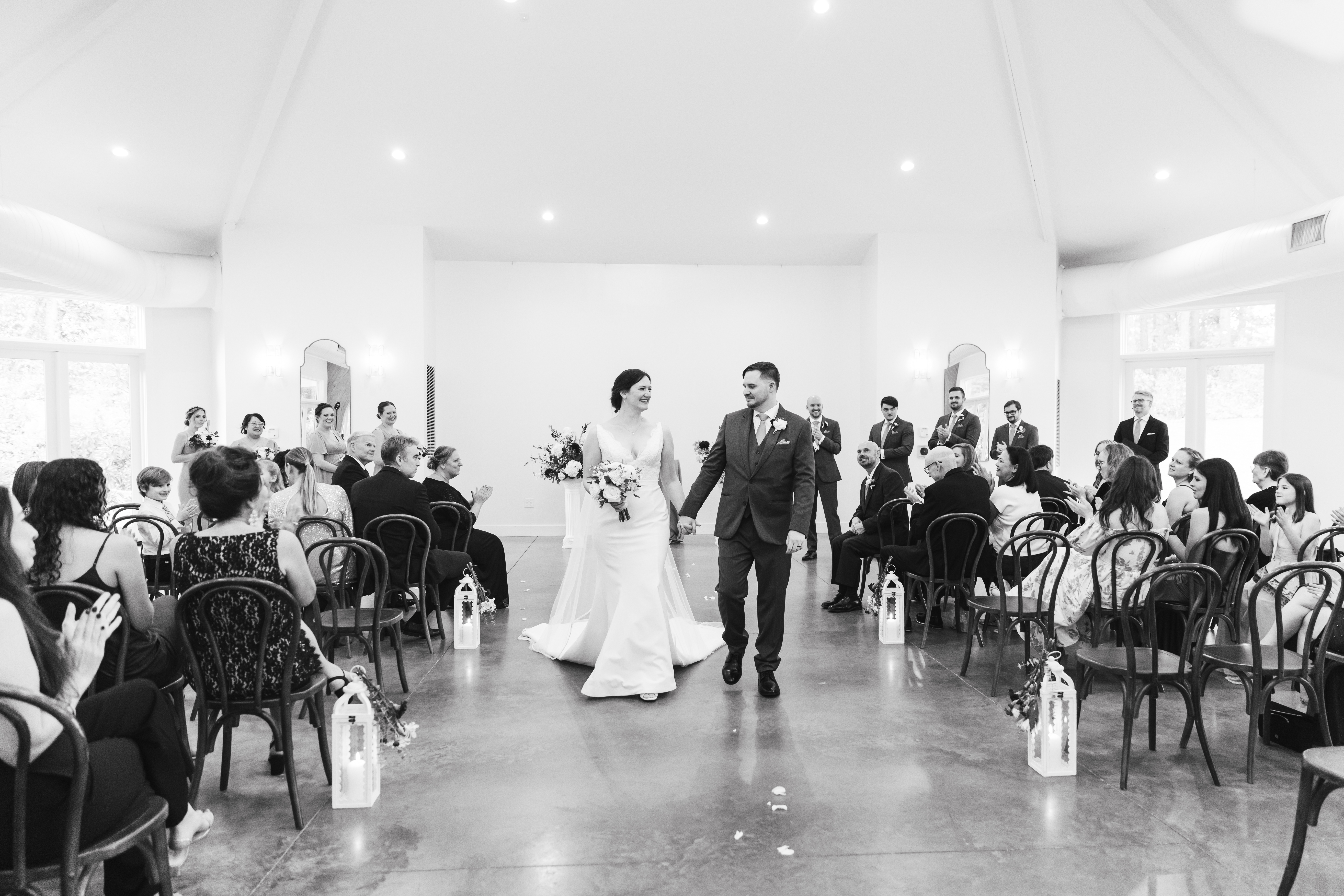 Bride and Groom walking up the aisle, holding hands and smiling after their indoor ceremony during a September wedding at the Upchurch in Cary, NC. 