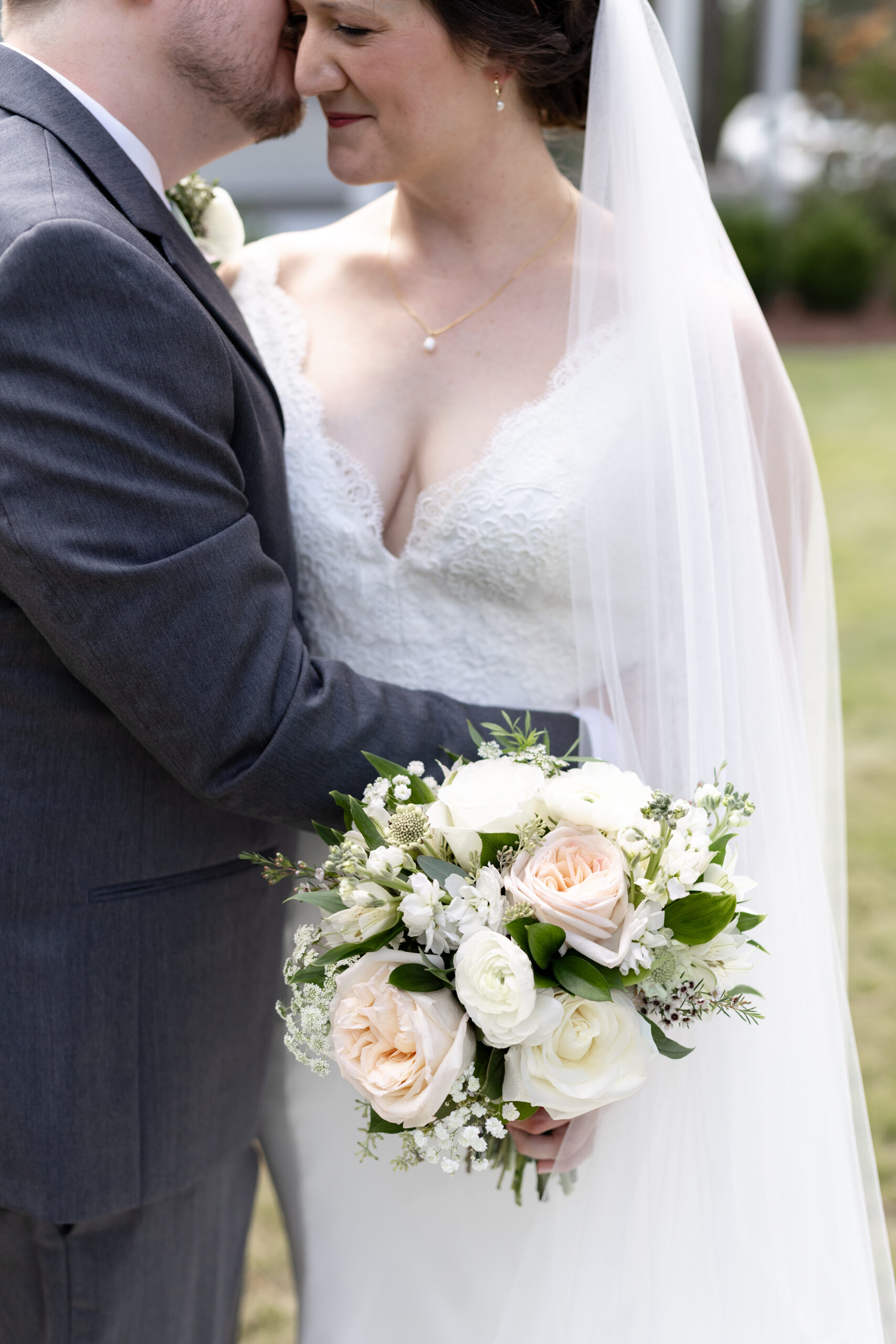 Romantic moment between bride and groom in front of the historic Upchurch-Williams Home at the Upchurch wedding venue.
