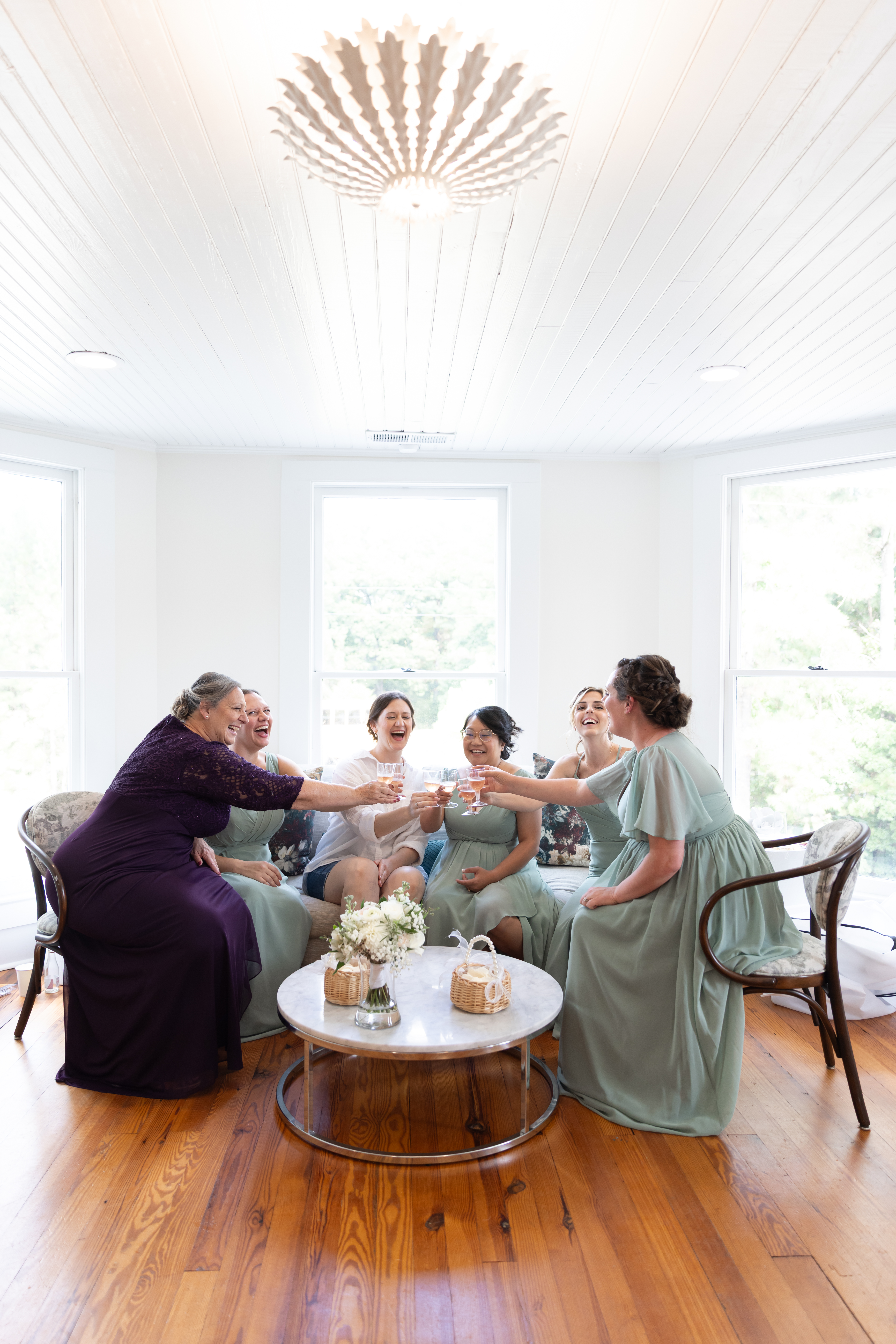 Bride and her girls having a toast during getting ready before a wedding at the Upchurch historic home.