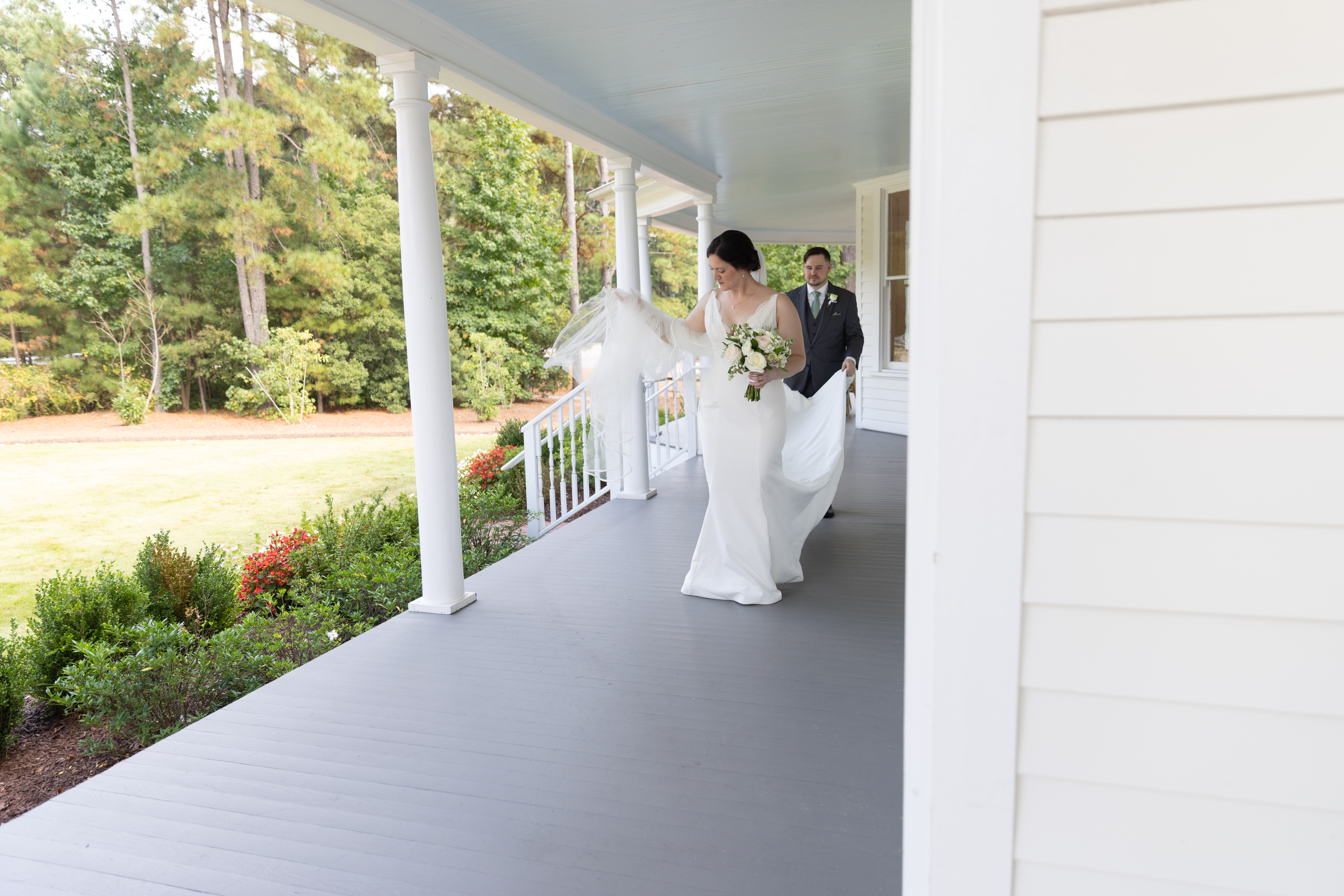 bride and groom heading for portraits on the porch of the Upchurch-Williams house in Cary