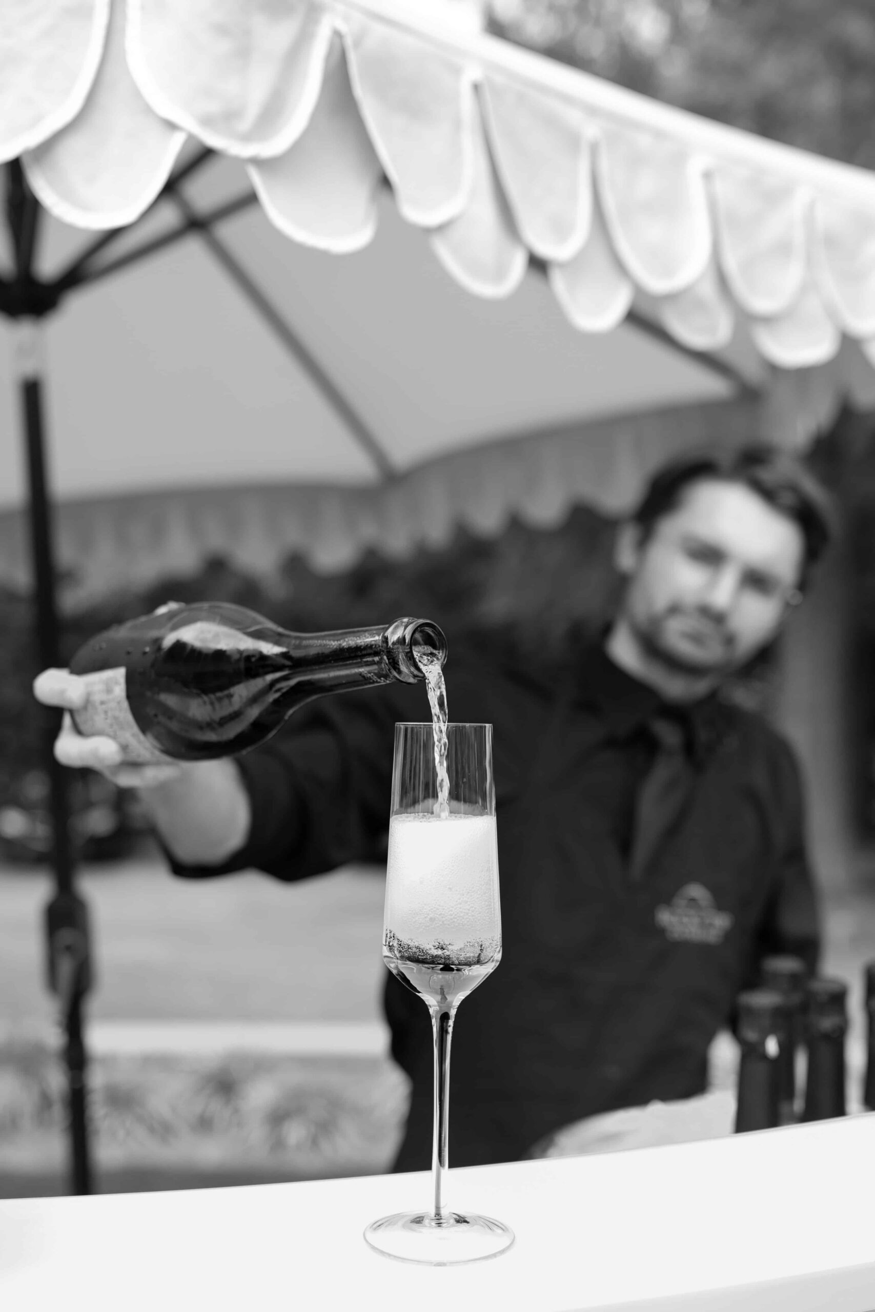 A bartender pouring a glass of champagne during a corporate event in Raleigh, NC by Raleigh event photographer
