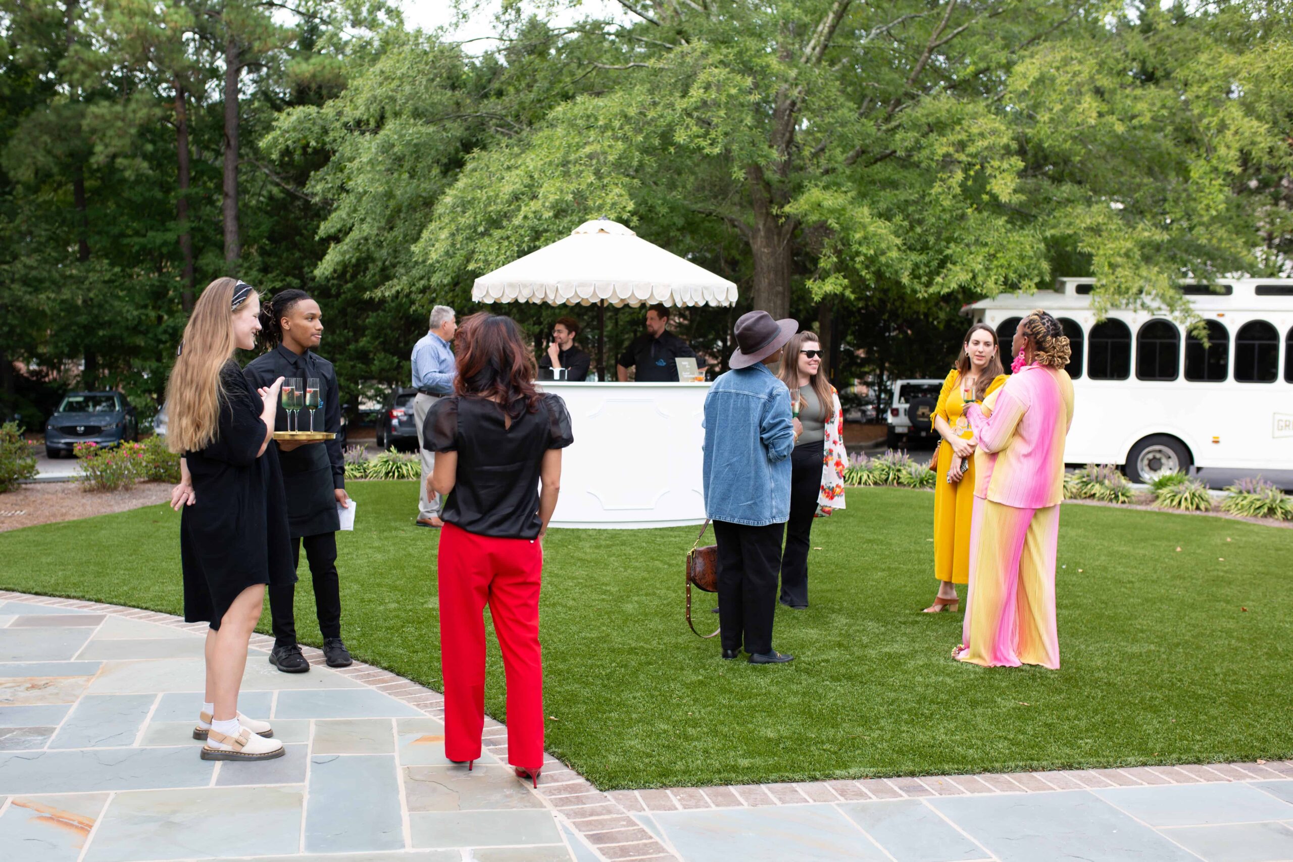 Guests enjoying their time on the lawn of Millbrook Manor in Raleigh, NC by Raleigh Event Photographer