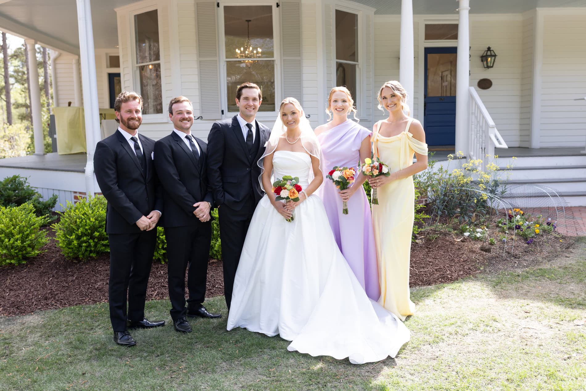 wedding party portrait in front of the upchurch historic house