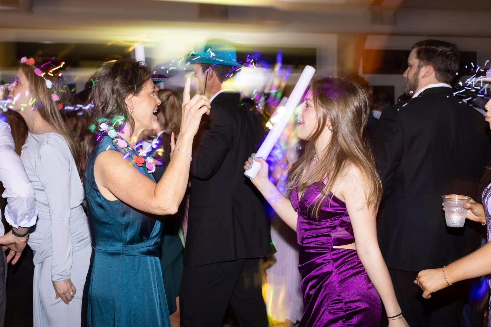 Mother of the groom dancing with her daughter during wedding reception at the Upchurch in Cary, NC.