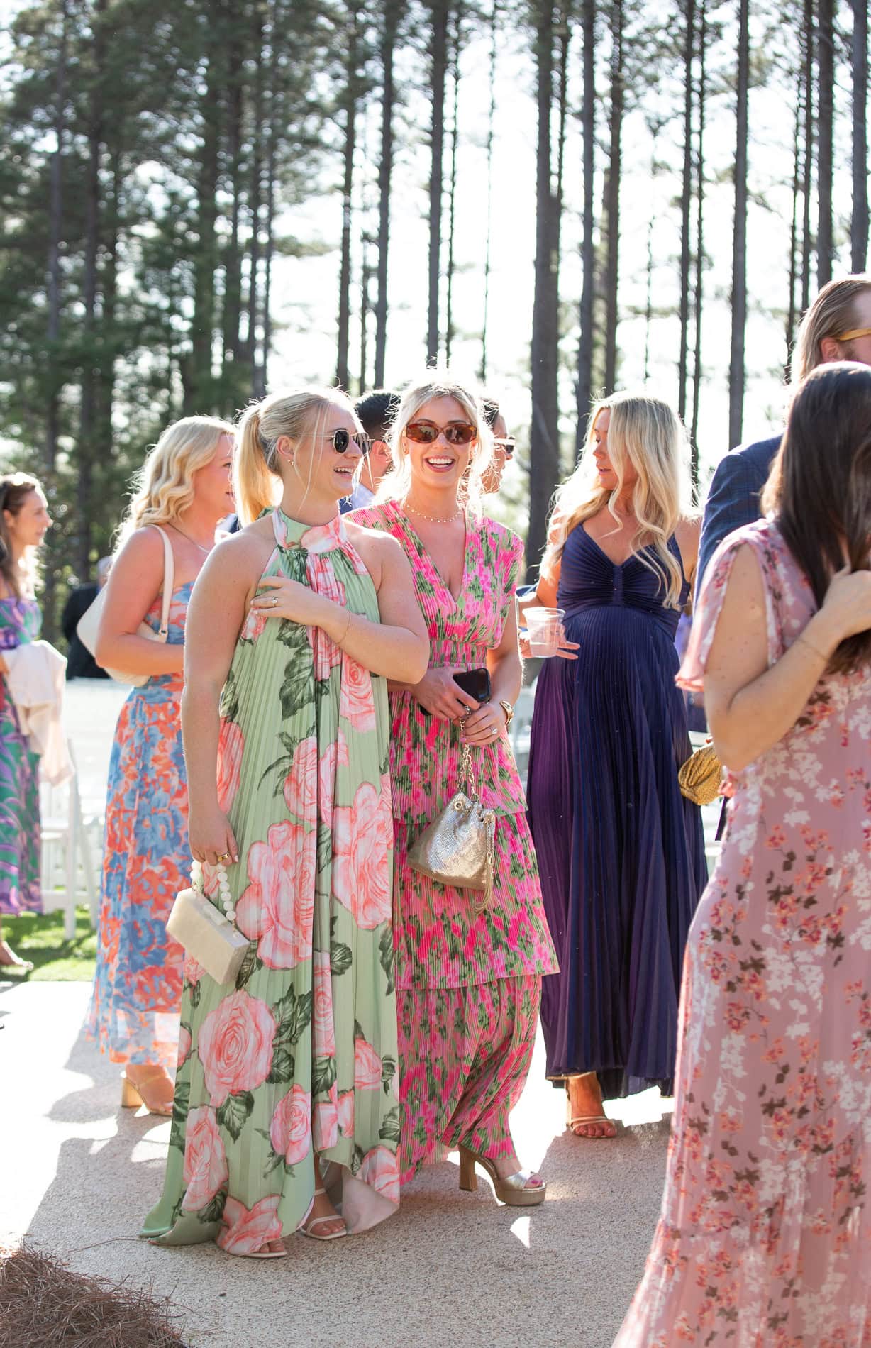 wedding guests wearing colorful, flowy maxi dresses during spring wedding at the Upchurch
