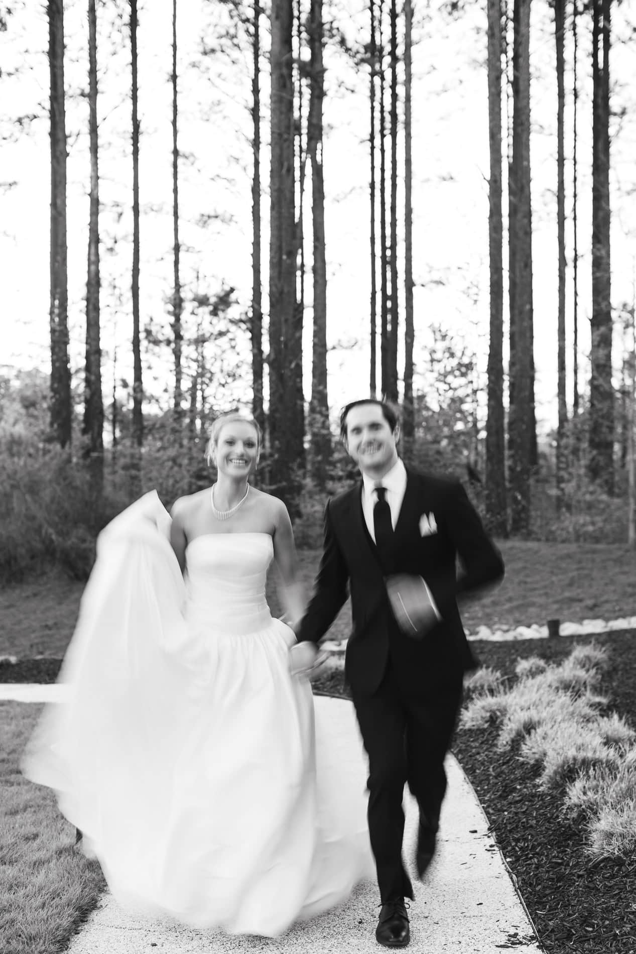 artsy, blurry, and movement-filled wedding photo of bride and groom running. the upchurch wedding photographer.