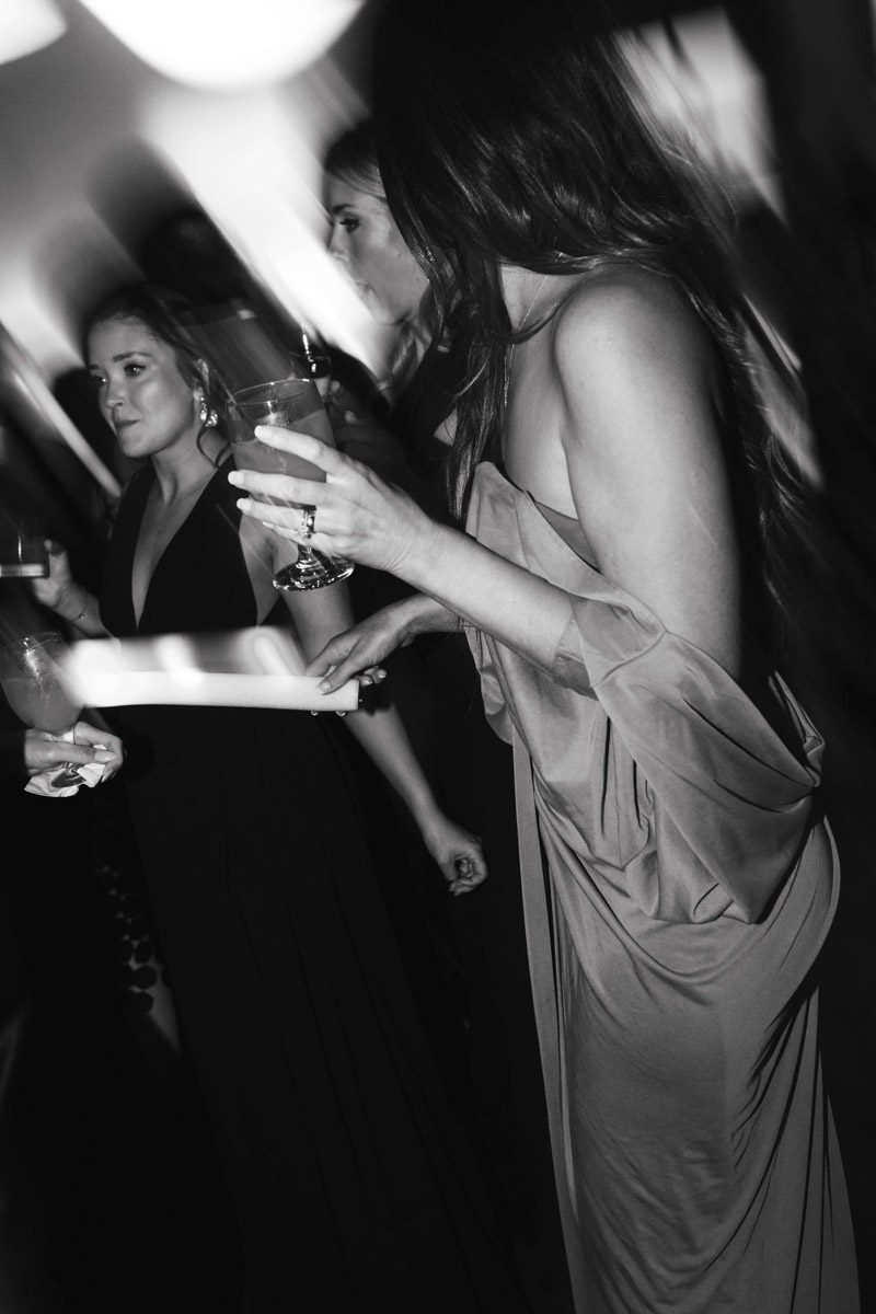 Black and white photo of women dancing during wedding reception at a wedding in Cary. Cary wedding photographer.